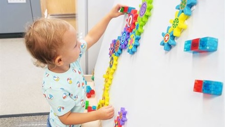 child with magnet toys